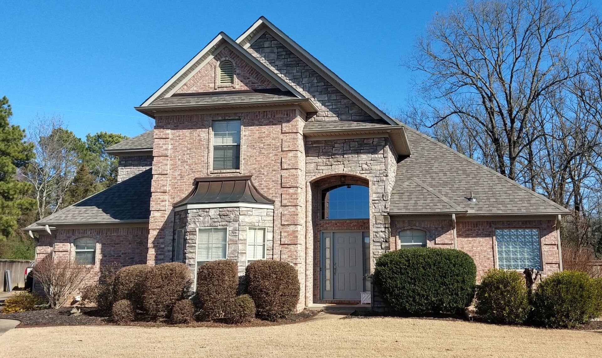 A large brick house with a gray roof