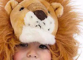 kid wearing a lion costume
