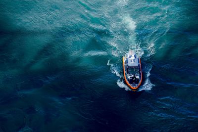 An aerial view of a boat floating on top of a large body of water.