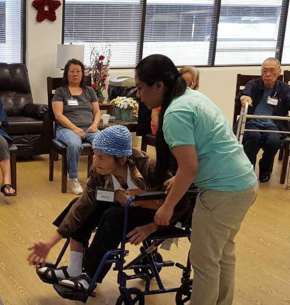 A woman is pushing another woman in a wheelchair