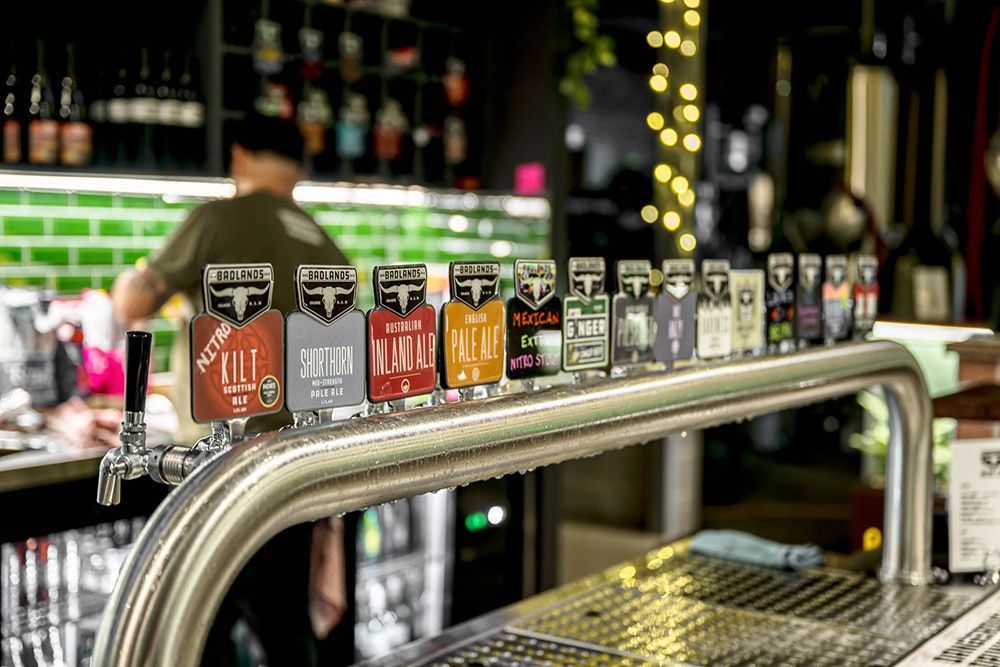 A Row of Beer Taps Are Lined up On a Bar — Construction & Renovation Services in Dubbo, NSW