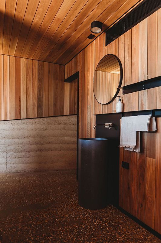 A Bathroom with A Sink, Mirror, and Wooden Walls — Construction & Renovation Services in Dubbo, NSW