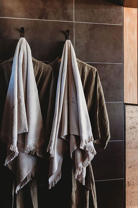 Two Towels Are Hanging on Hooks in A Bathroom — Construction & Renovation Services in Dubbo, NSW