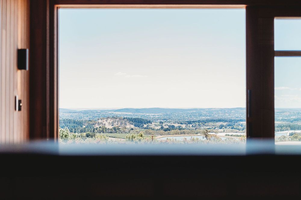 A Large Window with A View of A Valley and Mountains — Construction & Renovation Services in Dubbo, NSW