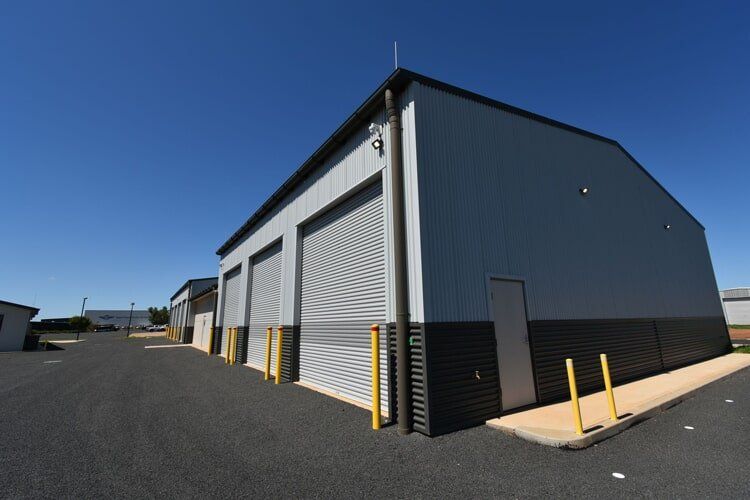 A Large Building With A Lot Of Garage Doors  — BLD Constructions in Dubbo, NSW