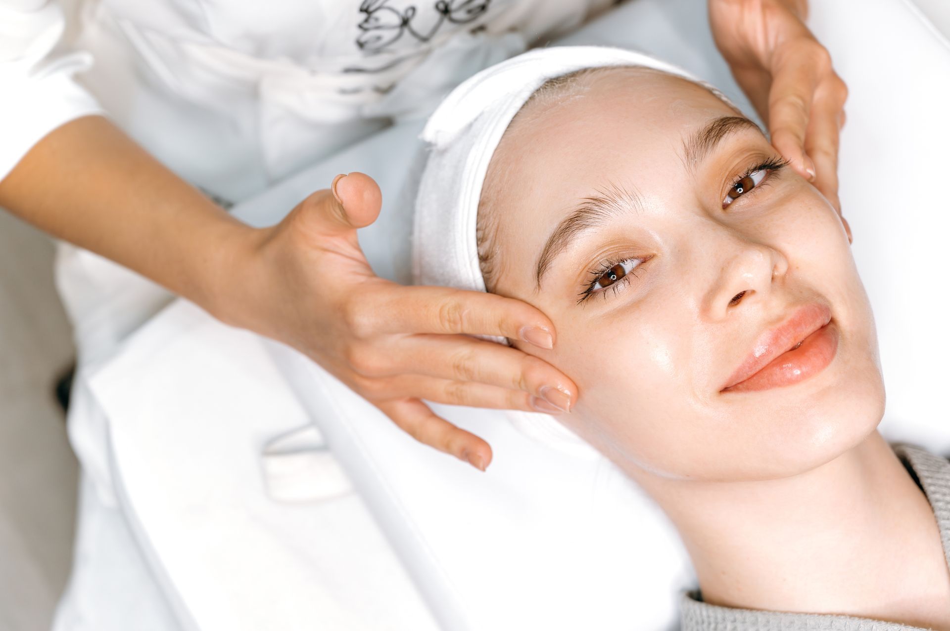 A woman is getting a facial treatment at a spa.