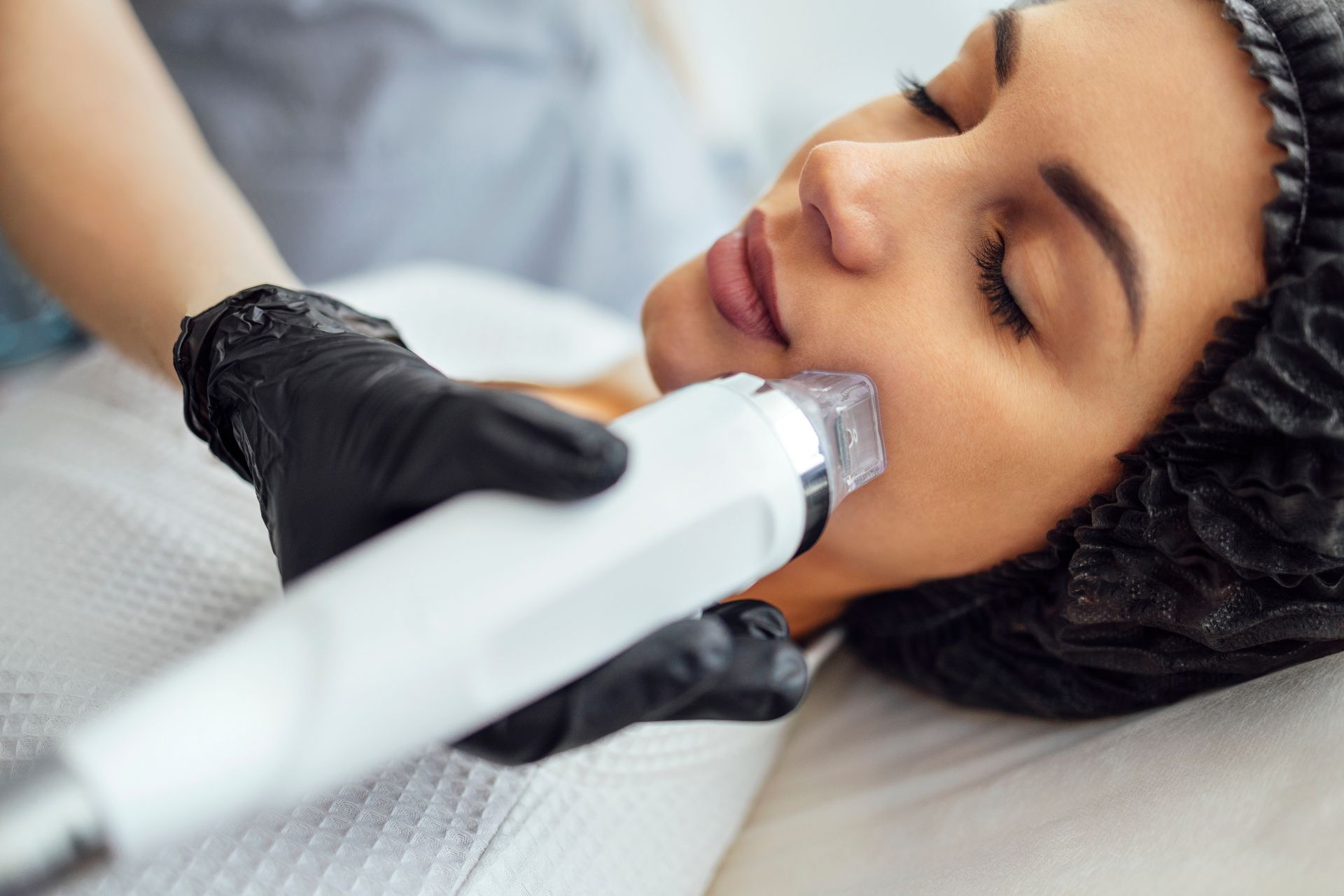 A woman is getting a facial treatment at a beauty salon.