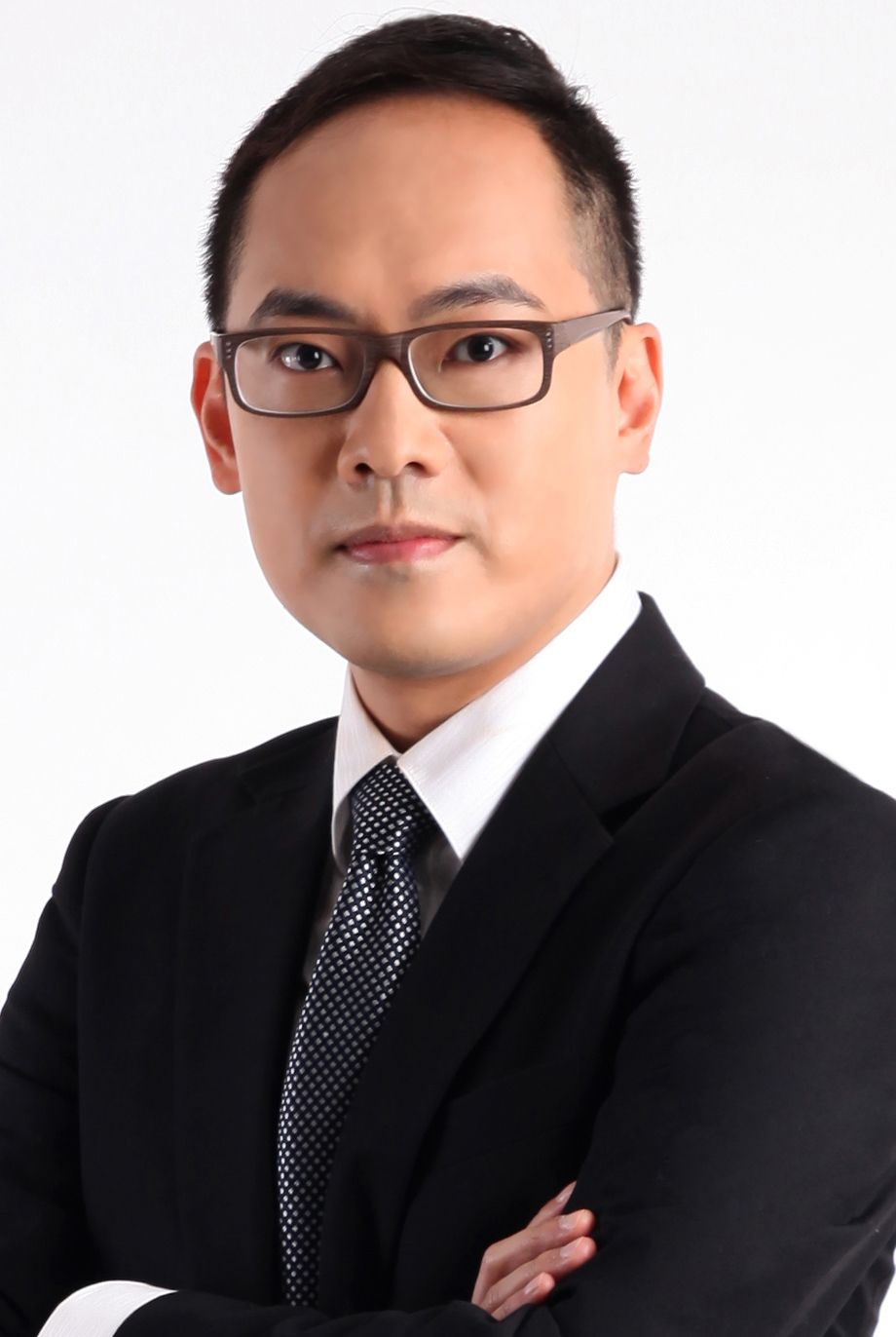 A lawyer called ricky wan in a suit and tie with his arms crossed