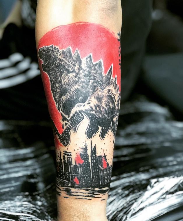 A person has a tattoo of a monster on their leg