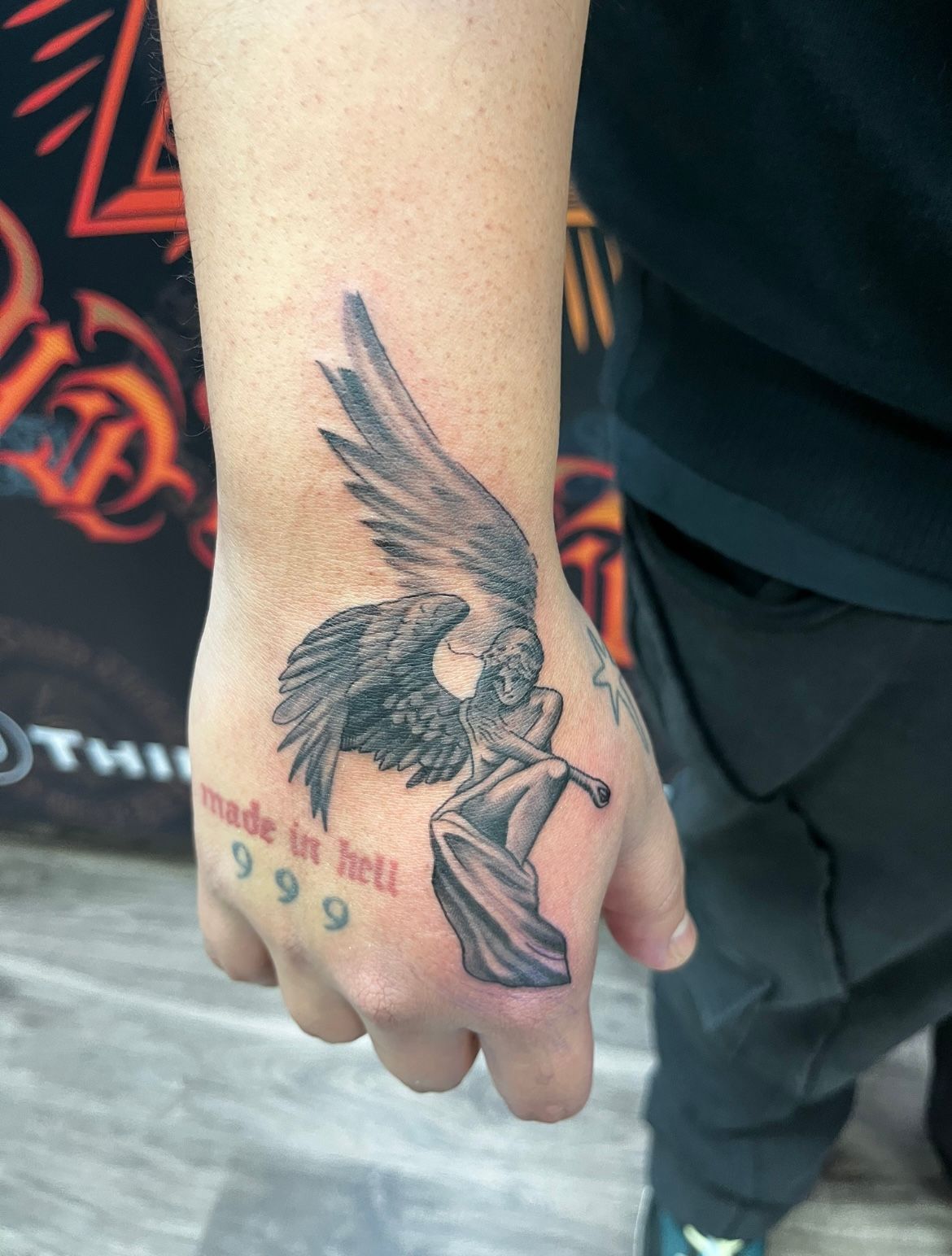 Hand tattoo: angel with wings,
