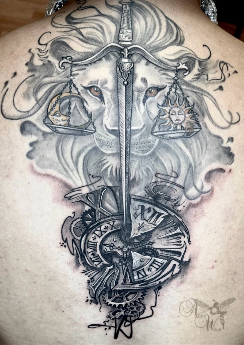 Lion with a scale-sword tattoo. Scales of justice, clockwork, and a sun symbol overlaying lion's face.