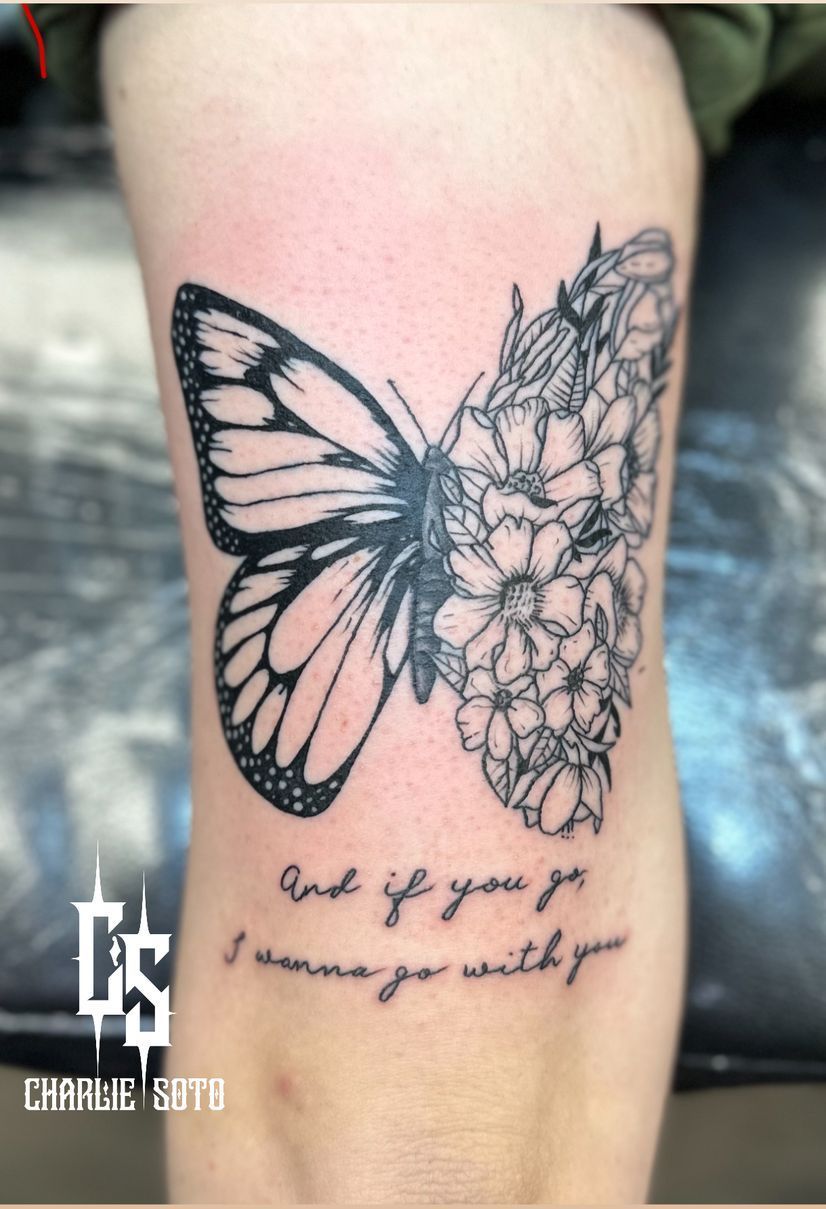 Butterfly tattoo on skin, half butterfly, half flowers. Text below: