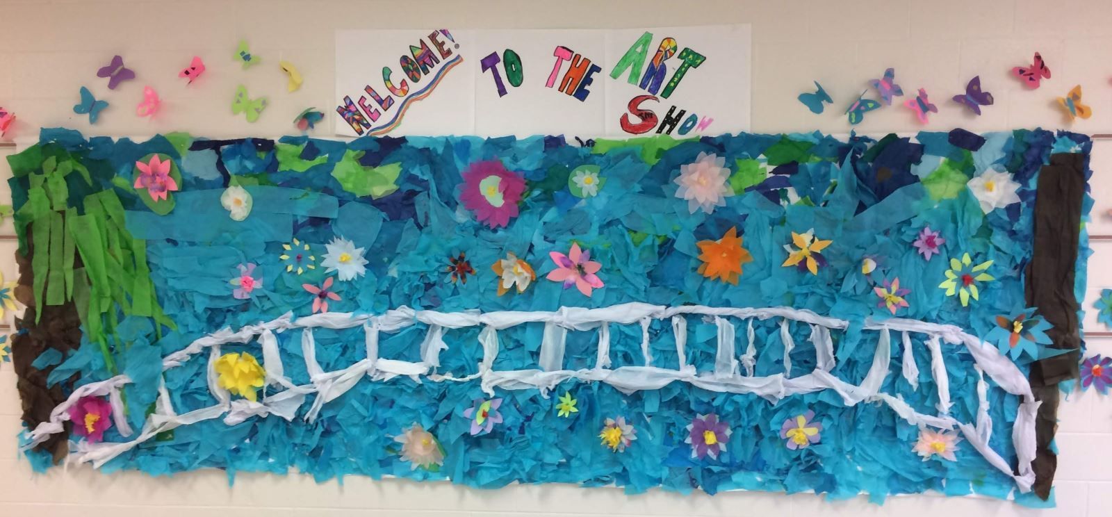 a blue bulletin board with a bridge and flowers on it