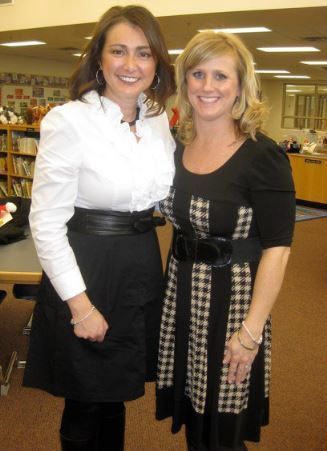 two women posing for a picture in a library