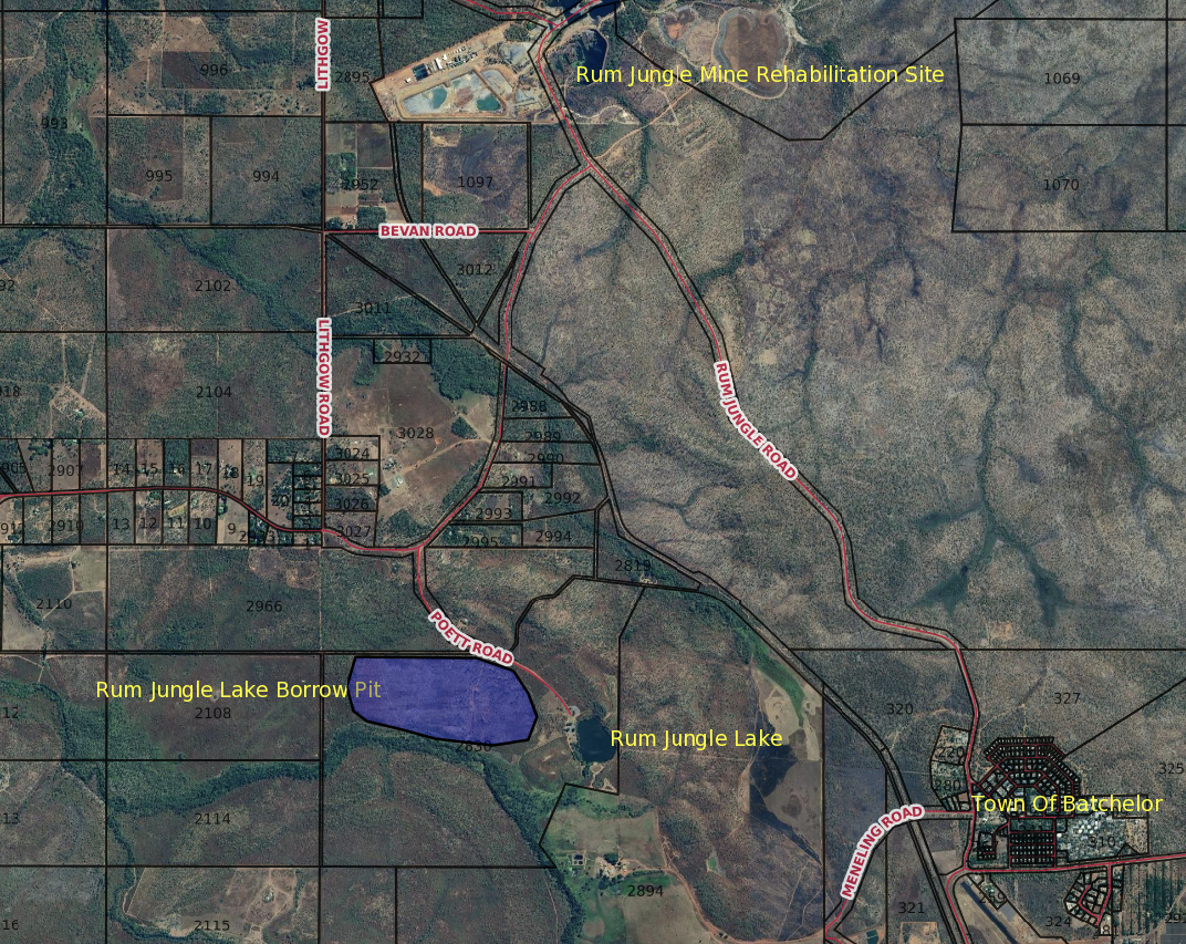 An aerial view of a landscape with a purple lake in the middle