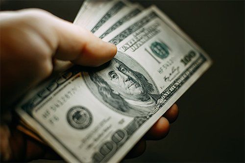 Man Holding US Dollar Bills