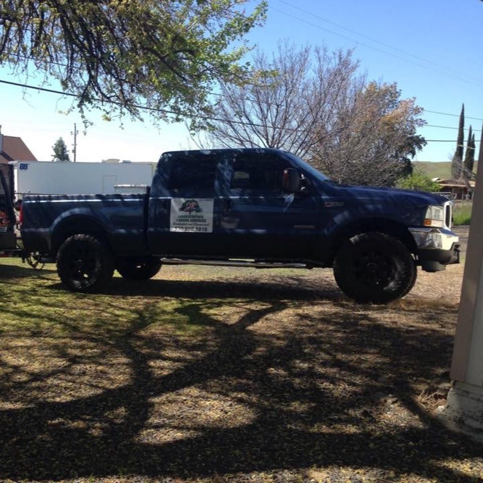 A Blue Pickup Truck Is Parked in A Driveway - Oroville, CA - JR Landscaping 