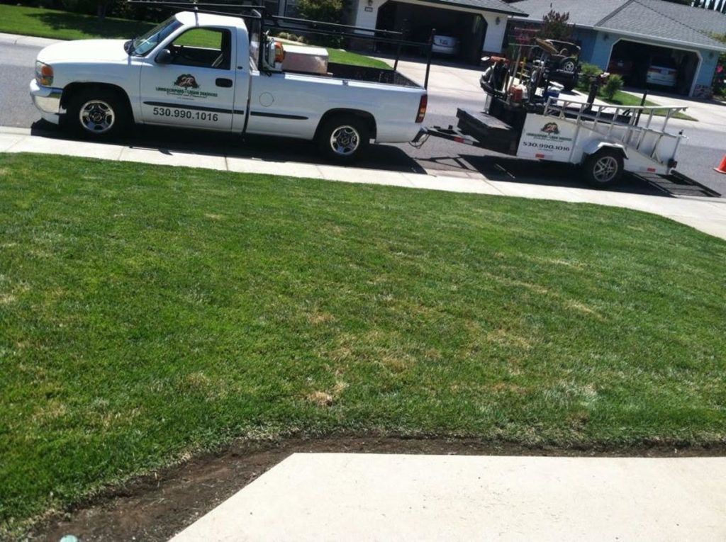 Two White Trucks Are Parked on The Side of The Road - Oroville, CA - JR Landscaping 