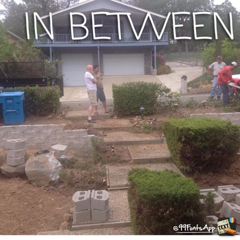A Group of People Standing in Front of A House that Says in Between - Oroville, CA - JR Landscaping 