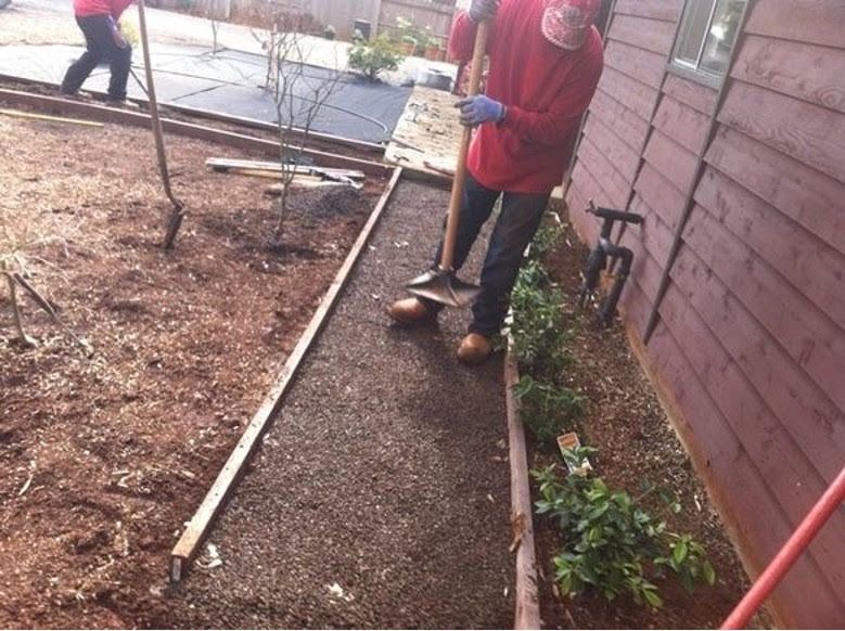 A Man in A Red Shirt Is Digging in The Dirt - Oroville, CA - JR Landscaping 