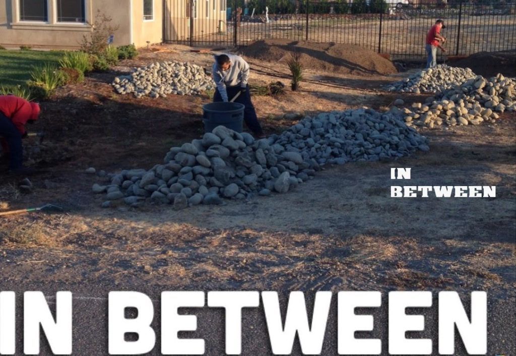 Two Men Are Working in The Dirt with The Words in Between Above Them - Oroville, CA - JR Landscaping 