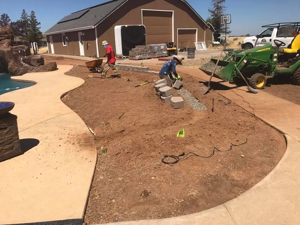 A John Deere Tractor Is Parked in Front of A House - Oroville, CA - JR Landscaping 