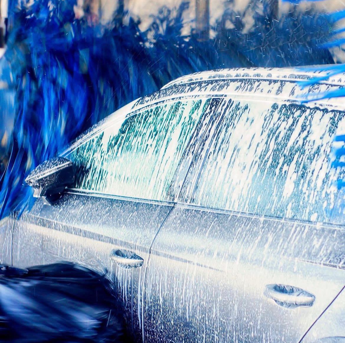 A car is being washed in a car wash.
