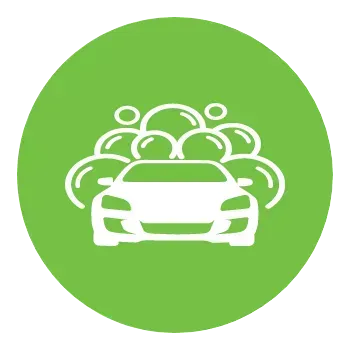 A car is being washed with soap bubbles in a green circle.