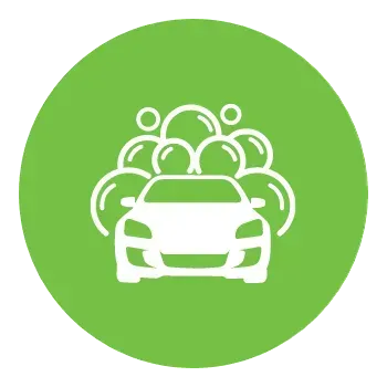 A car is being washed with soap bubbles in a green circle.