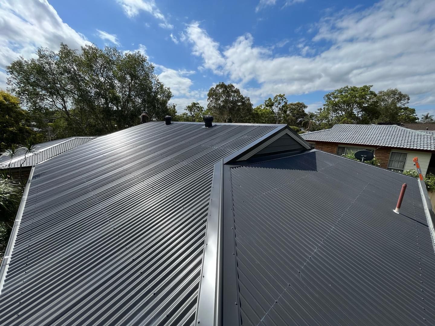 A roof of a house with a blue sky in the background