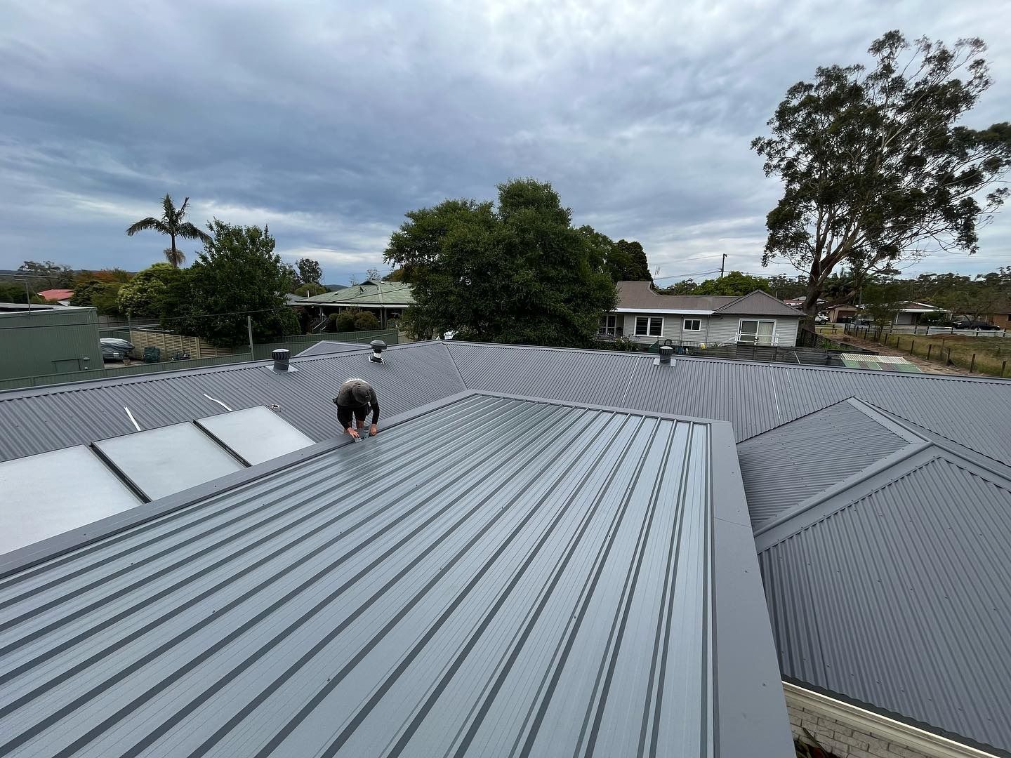 Roofer Working on Grey Rooftop