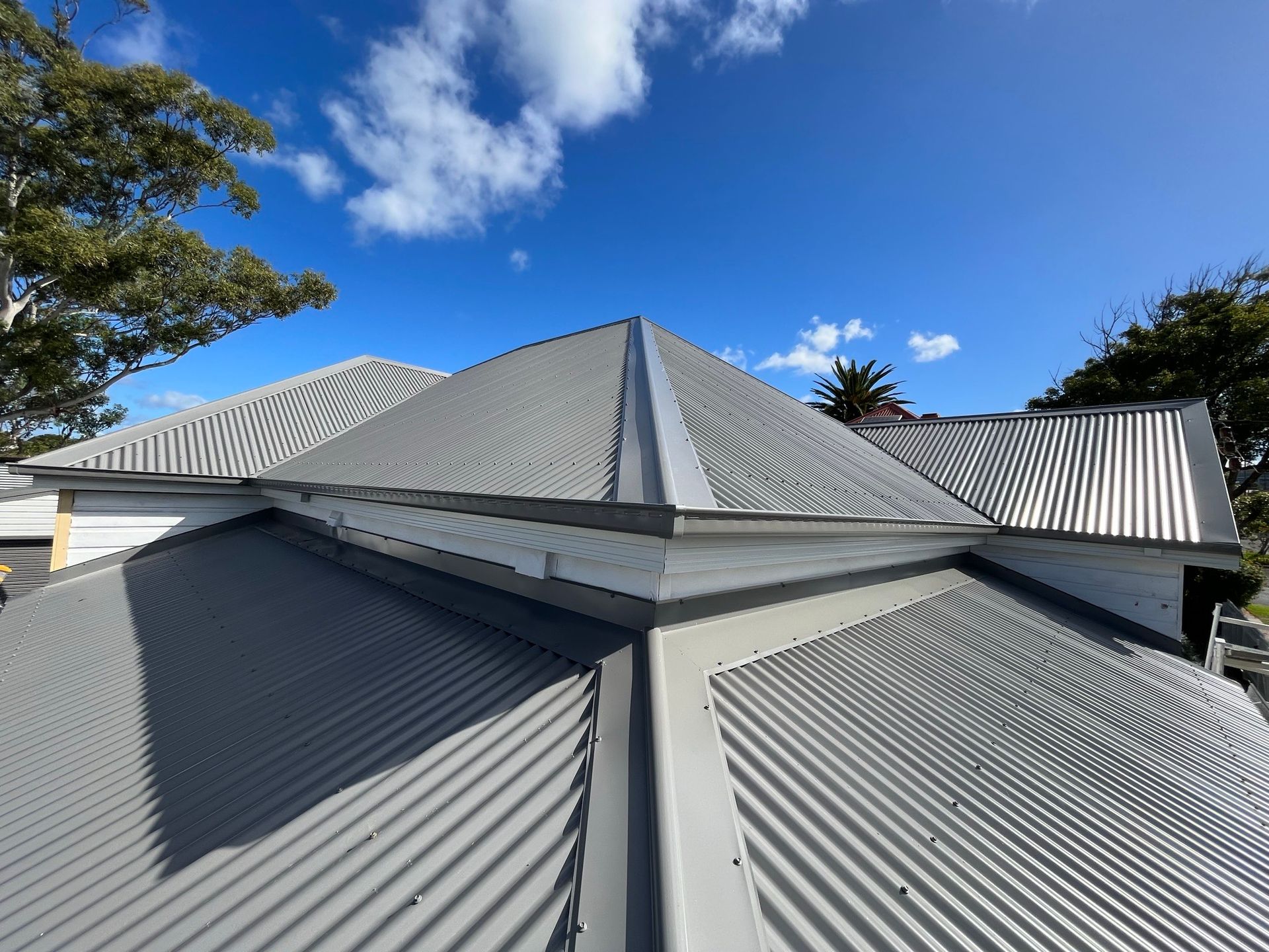 Shadowed Man Working on a Roof — Roofing in Newcastle, NSW