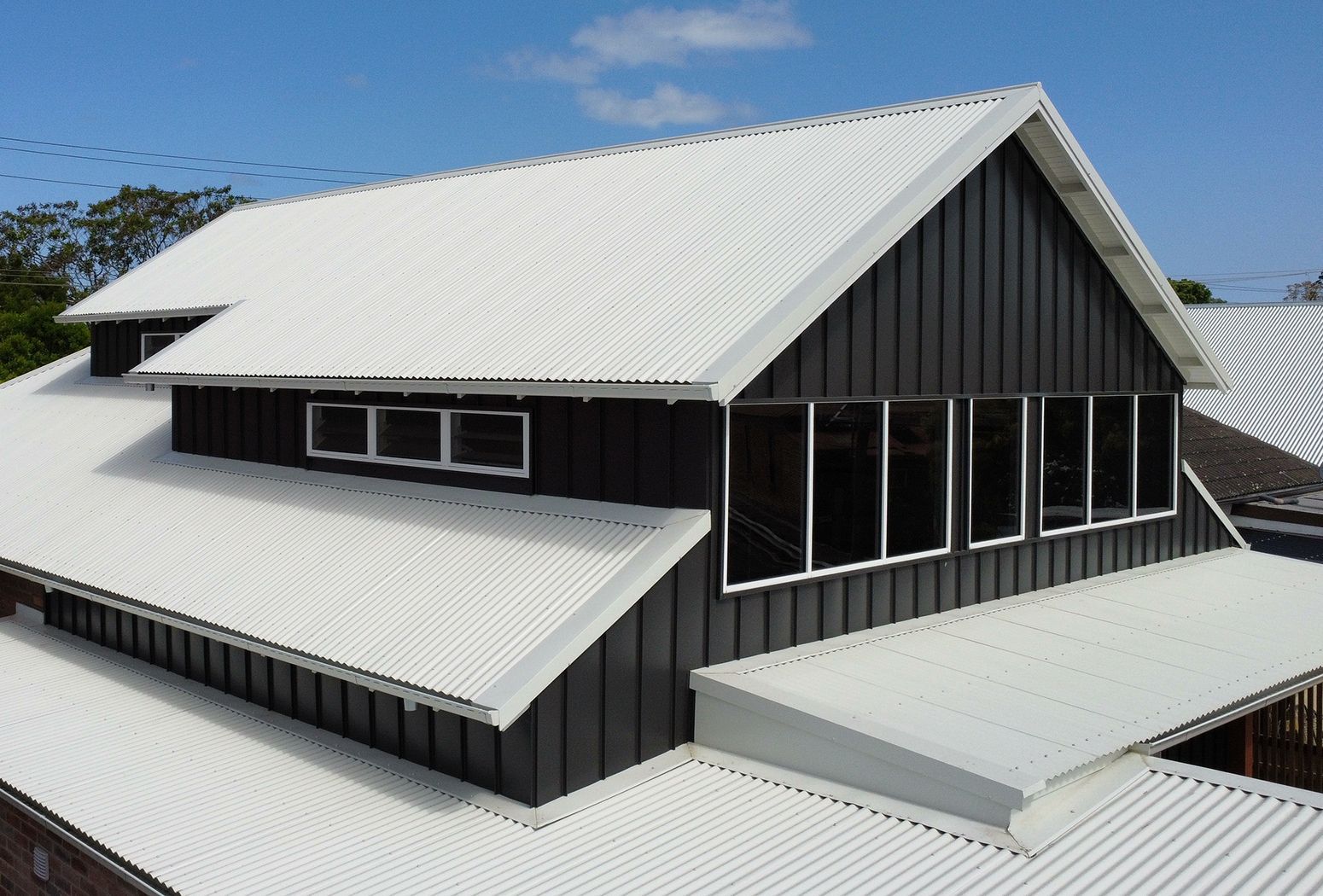 Dark Gray Building with a White Corrugated Metal Roof — Roofing in Newcastle, NSW
