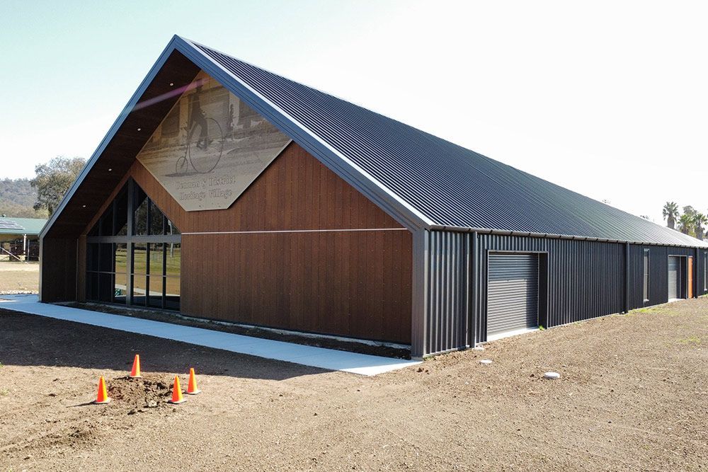 A Large Building with a Roof That Looks Like a Barn — Roofing in Newcastle, NSW