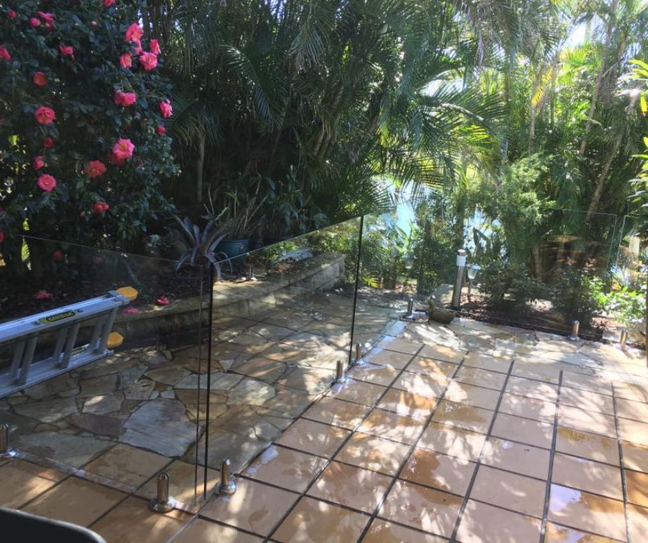 Get Wet Cleaning Services' professional pressure cleaning on patio glass fence