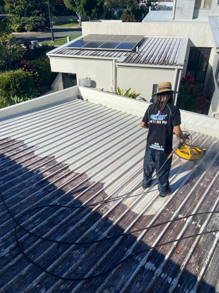 Get Wet Cleaning staff pressure washing a residential roof