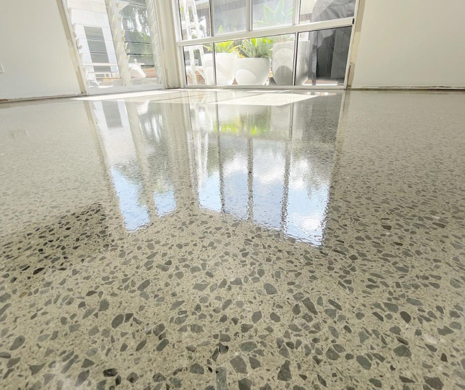 Polished indoor floor showcasing a high-gloss finish achieved through concrete sealing, with reflect