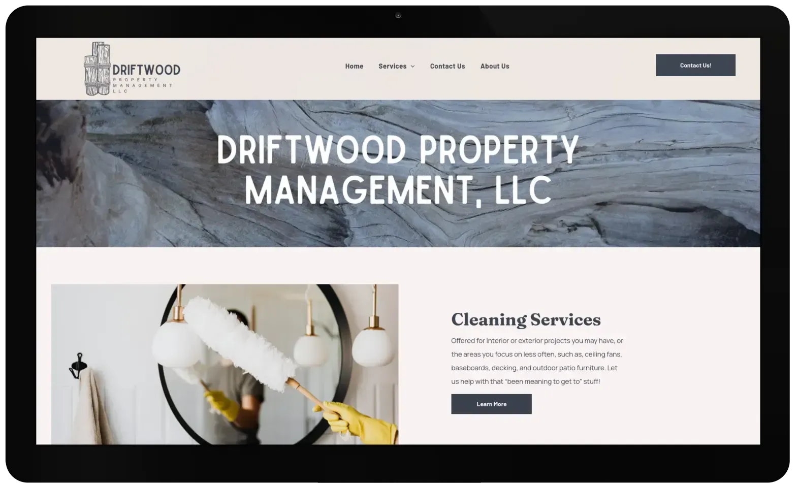 The website for driftwood property management llc shows a woman cleaning a mirror.
