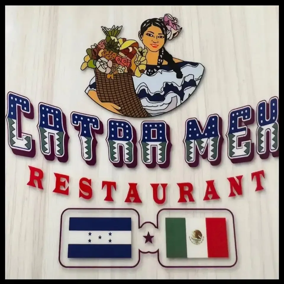 A sign for catra men restaurant shows a woman holding a basket of fruit
