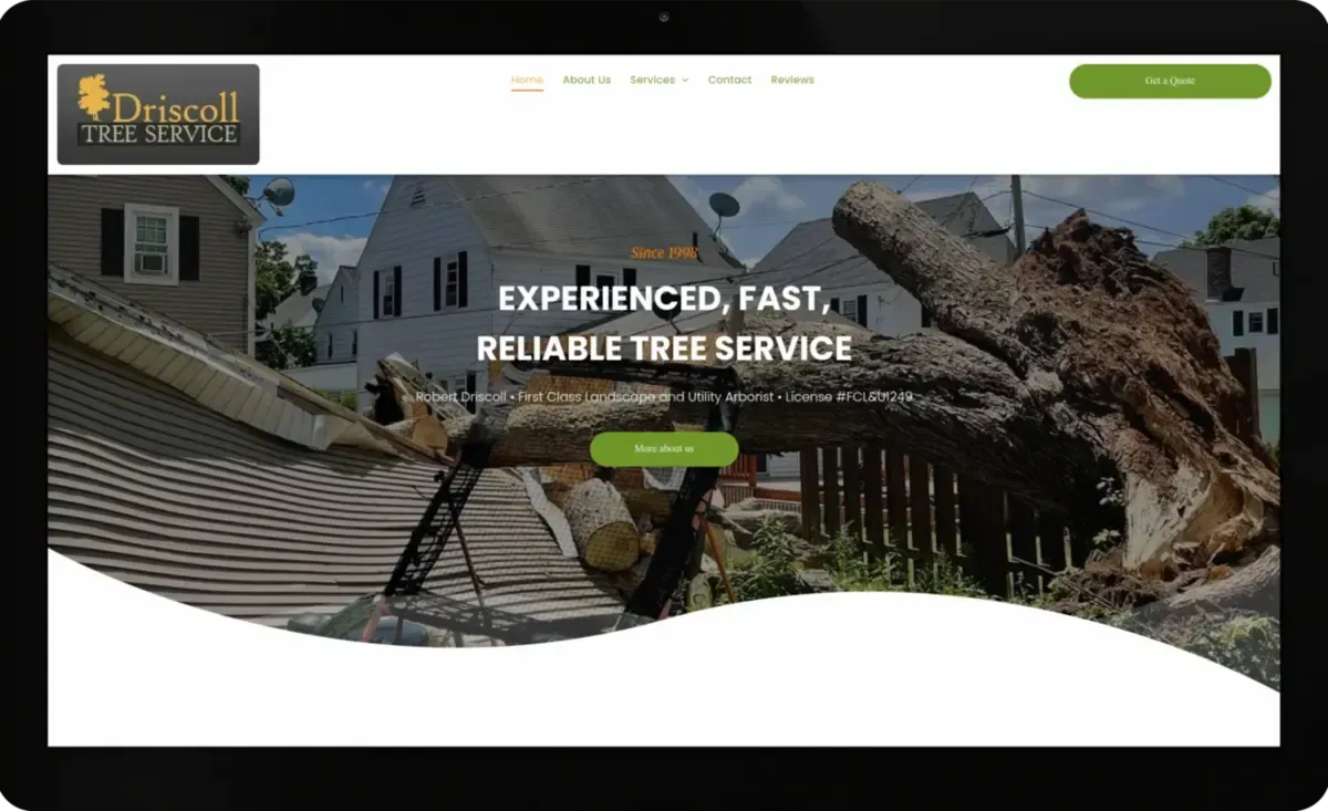 A computer screen shows a website for driscoll tree service