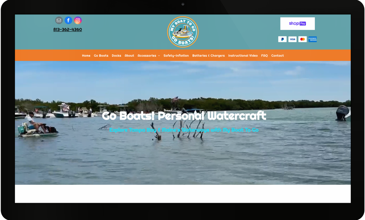 A computer screen shows a website for boats personal watercraft.