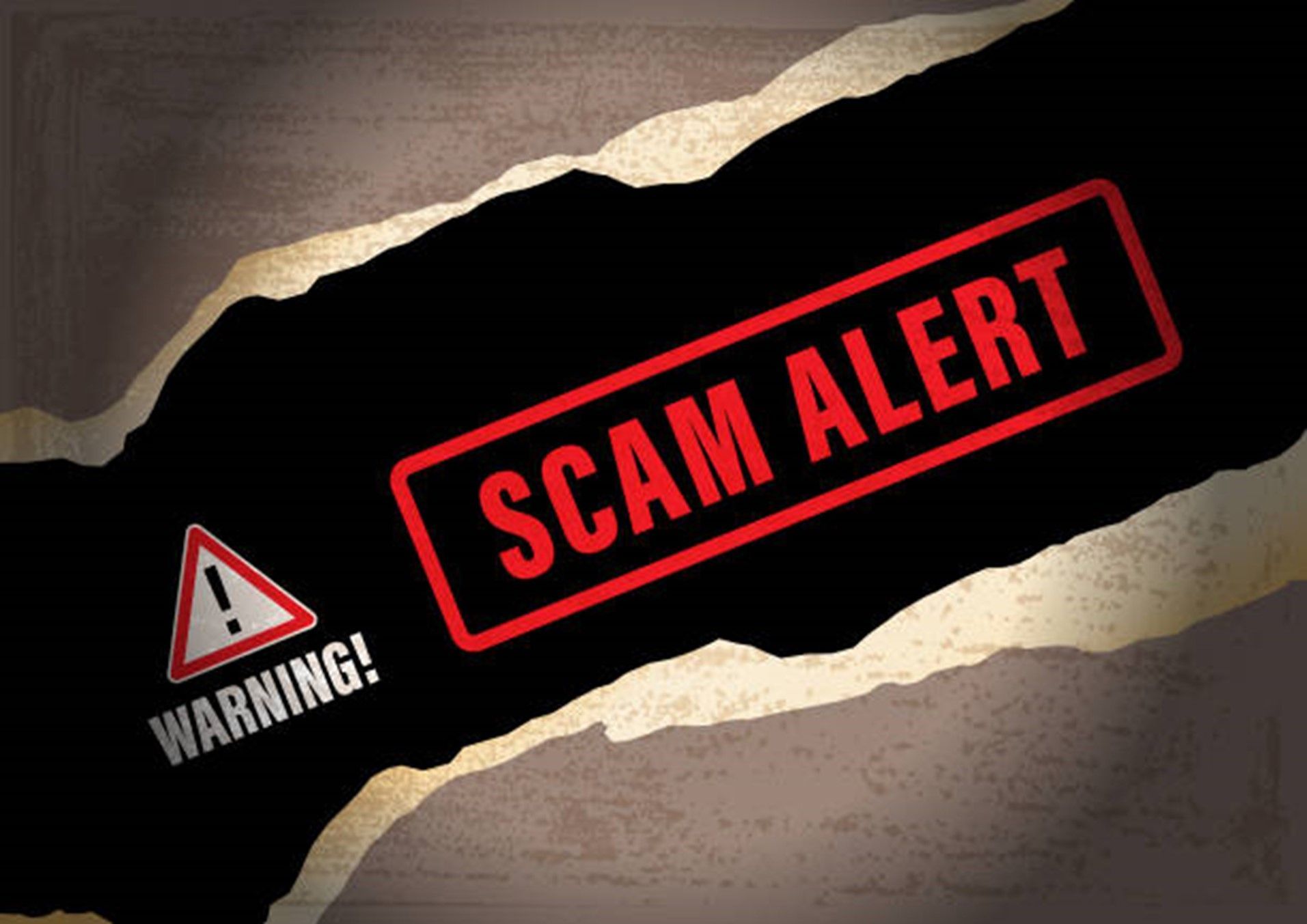 A warning sign that says scam alert on it