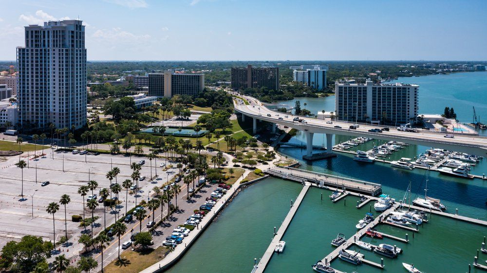 An aerial view of a city with boats docked in the water.
