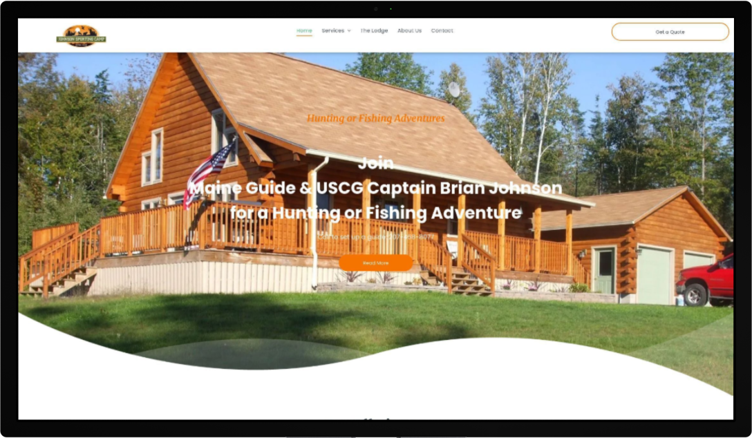 A computer screen shows a log cabin with a red truck parked in front of it.