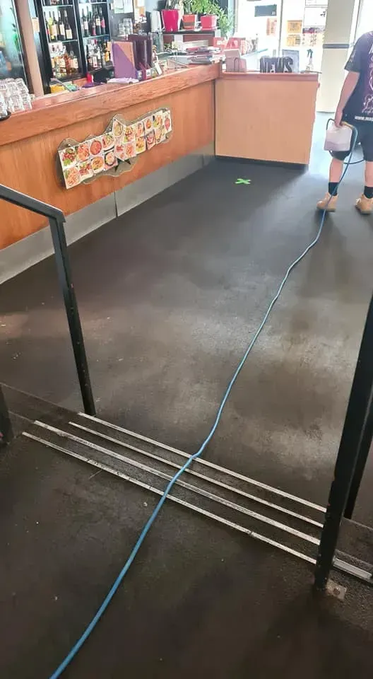 A Blue Cable Stretches Across a Dark Floor — Magic Mist Carpet Cleaning in Gracemere, QLD