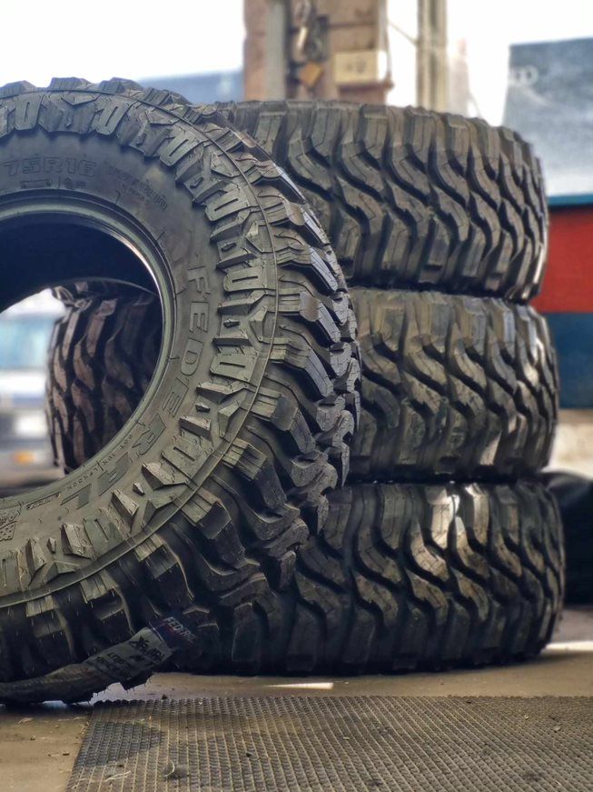 A Stack of Tires Sitting on Top of Each Other on a Table — BJM Mechanical Mufflers & Tyres In Oxenford, QLD