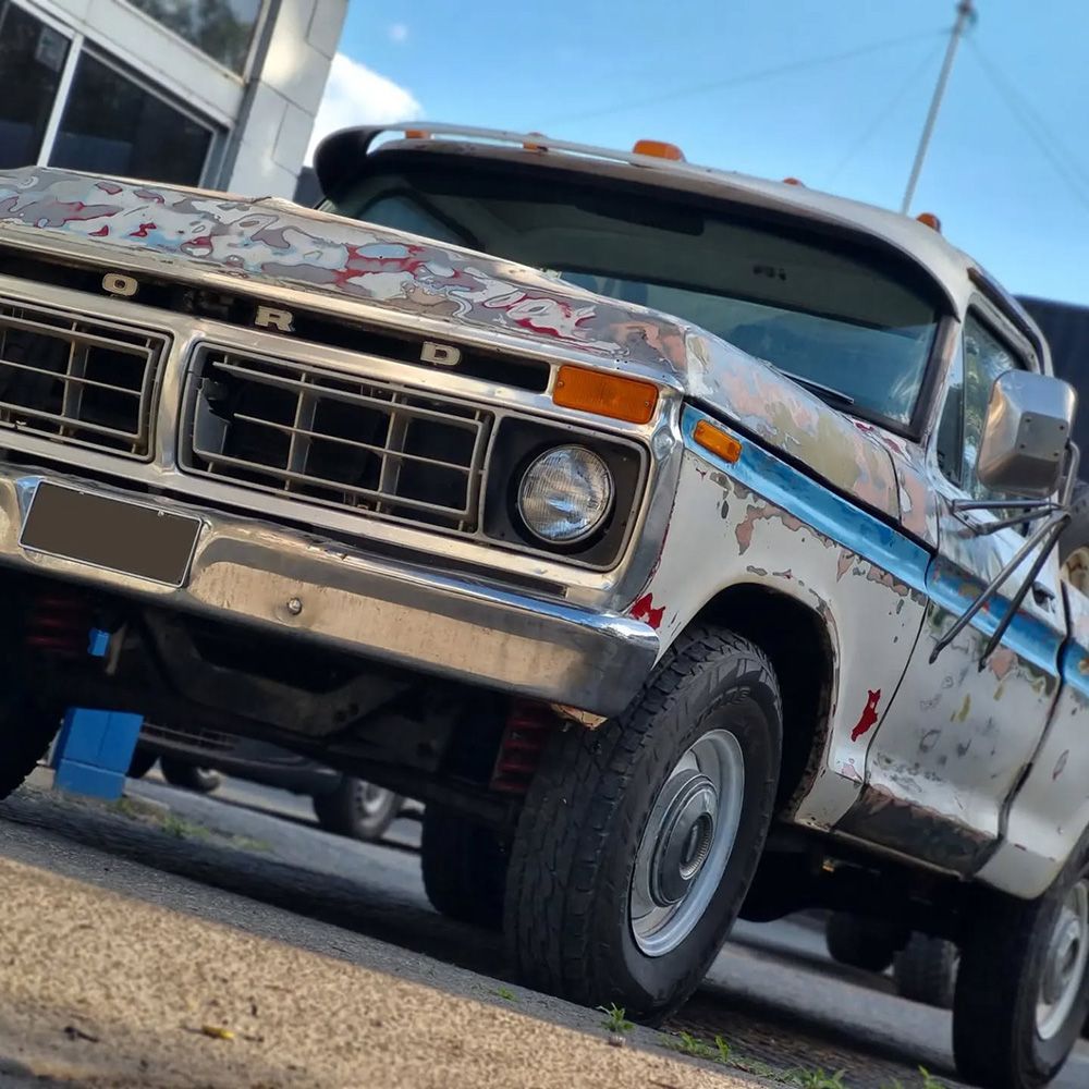 A Weathered White Ford Pickup Truck Parked Outside — BJM Mechanical Mufflers & Tyres On The Gold Coast, QLD