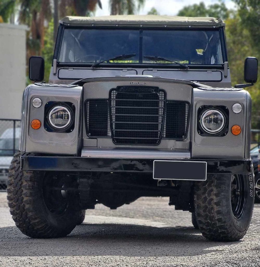 Gray Land Rover Defender Off-Road Vehicle With Large Tires — BJM Mechanical Mufflers & Tyres On The Gold Coast, QLD