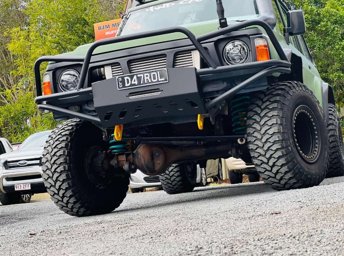 A Green Jeep is Parked on the Side of the Road — BJM Mechanical Mufflers & Tyres In Oxenford, QLD