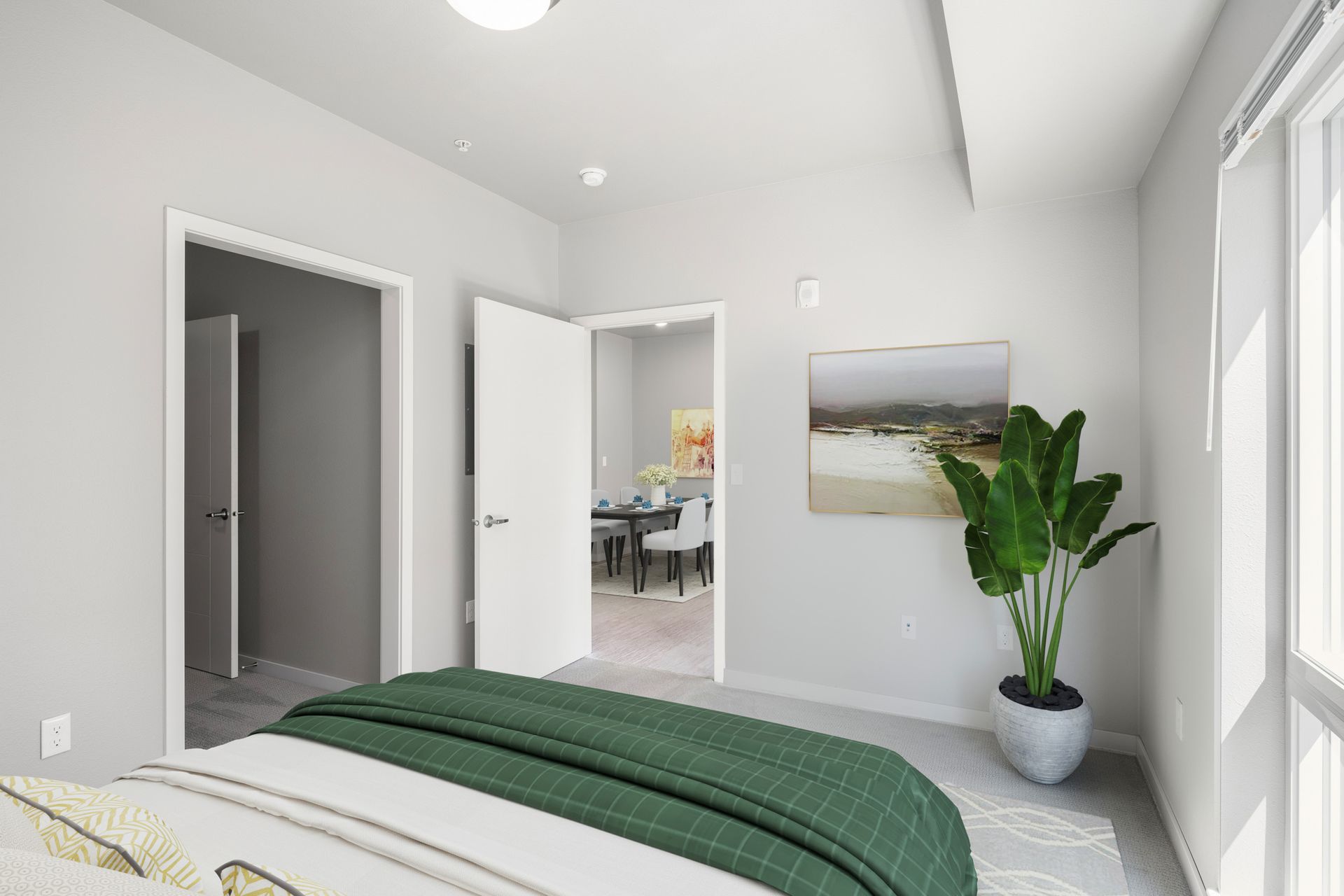 Bedroom interior with bed, green blanket, potted plant, and open doorways.